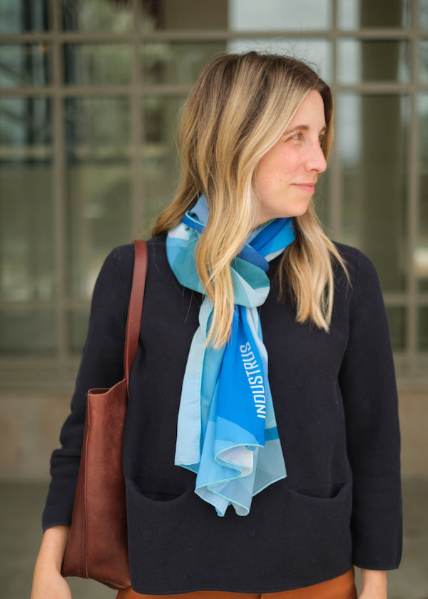 woman wearing a blue scarf with company logo