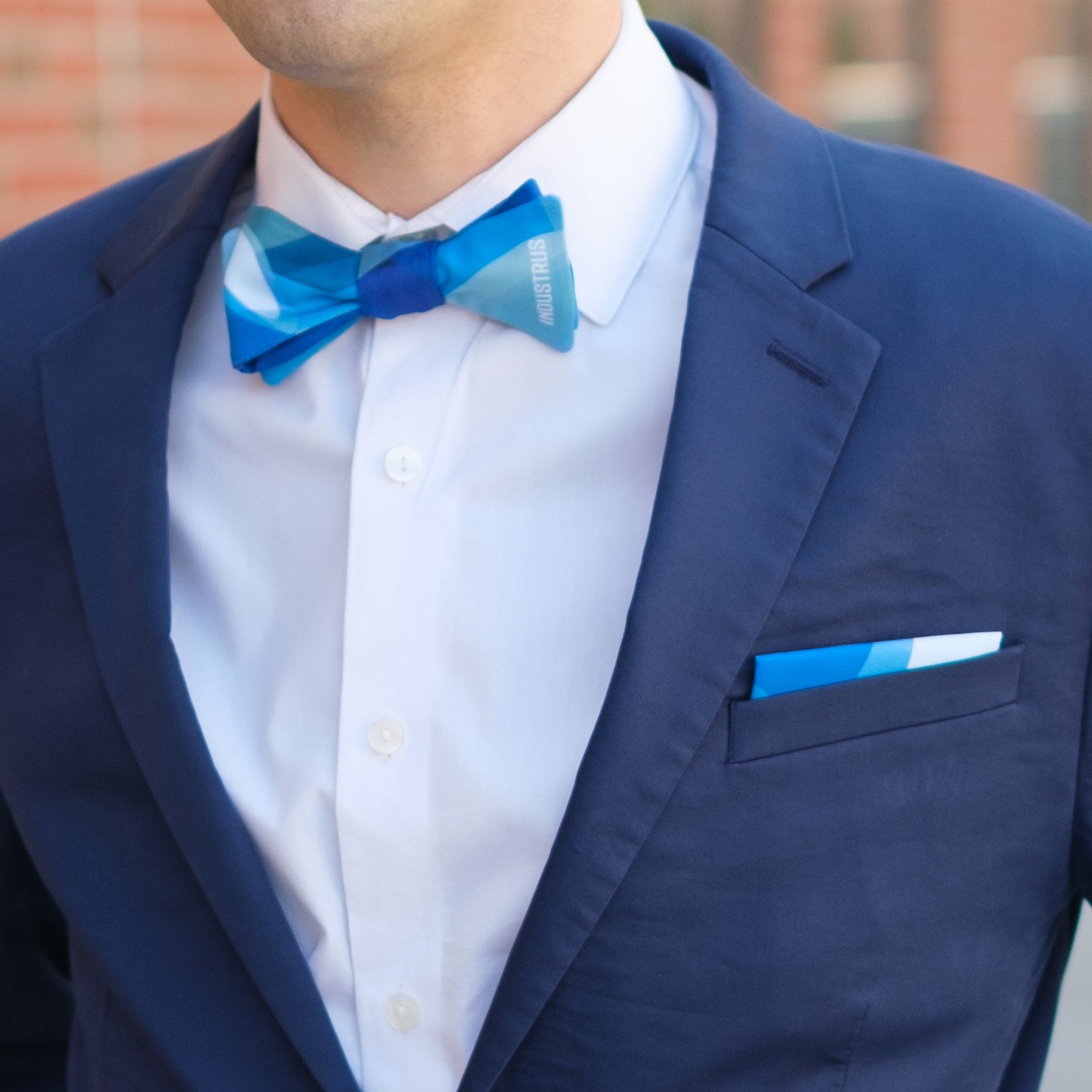 man wearing custom abstract branded bow tie and matching pocket square