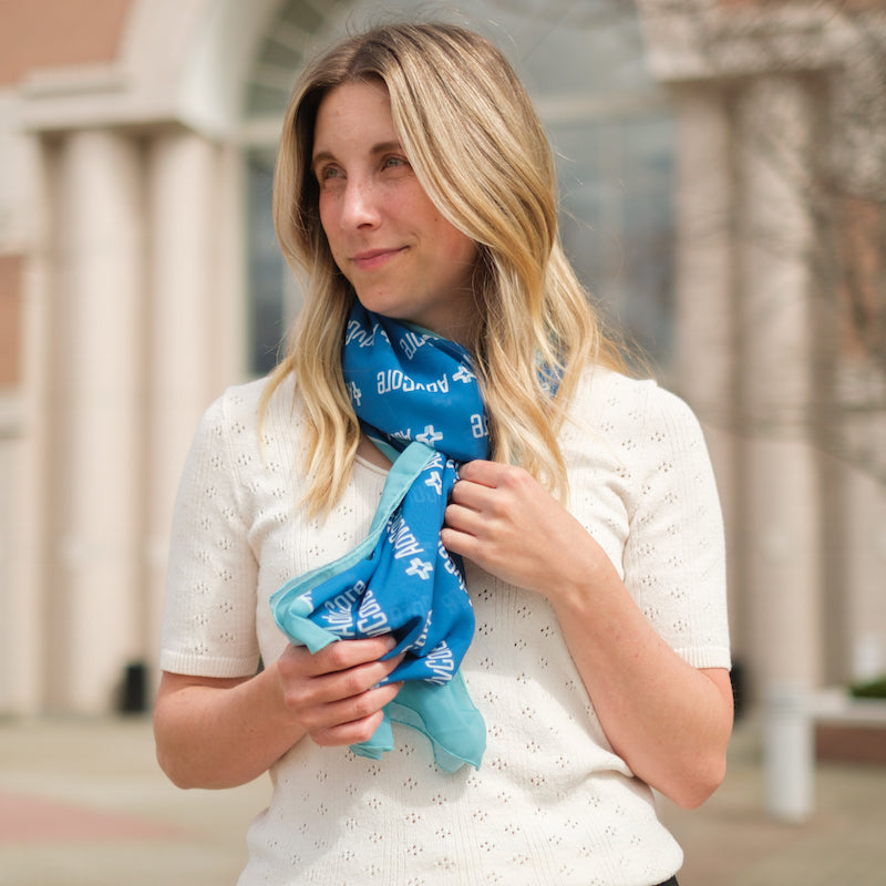 woman wearing logo company scarf