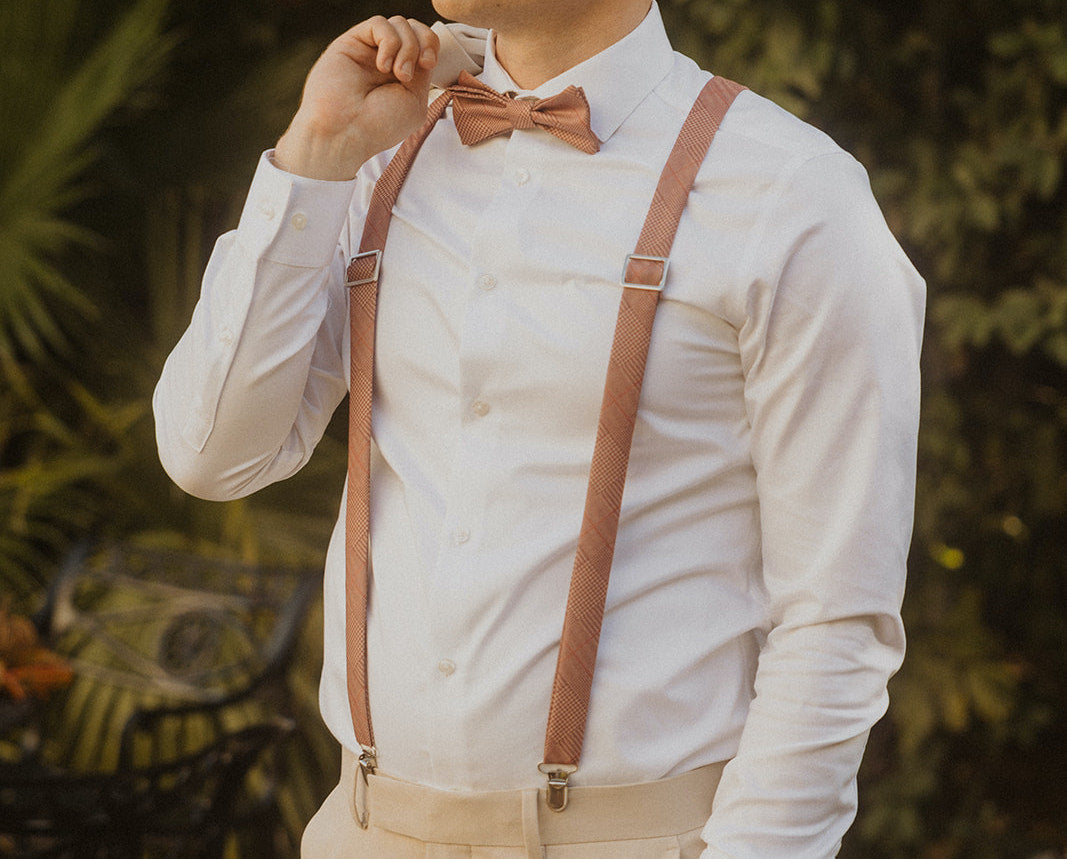 photo of man wearing bow tie suspenders and white shirt